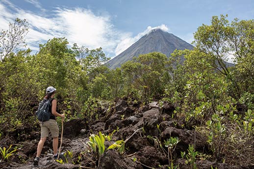 A hiker on a trail around the Arenal Volcano